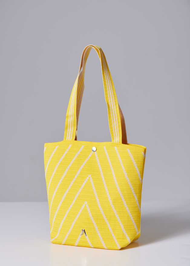 Yellow woven handbag with white diagonal stripe design, lightweight eco-friendly fabric tote bag with sturdy handles for everyday use