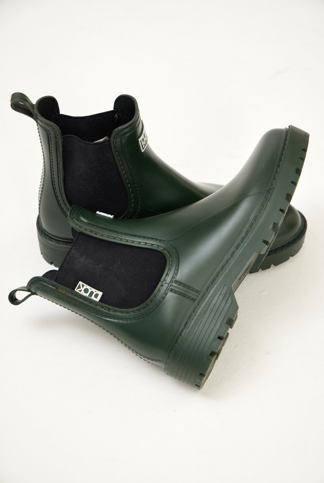 Green Ankle-length gumboots with elastic side panels and durable sole, designed for everyday outdoor and wet-weather use