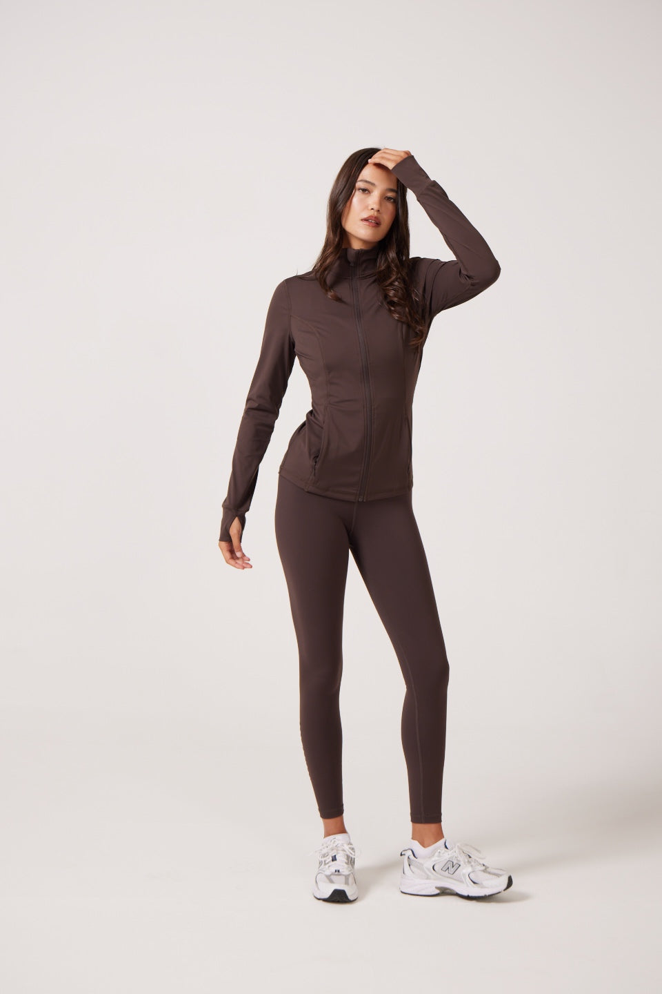 Brown Lightweight performance jacket with a smooth, sculpting fit, full zip front, high collar, and stretch fabric designed for everyday movement and layering.