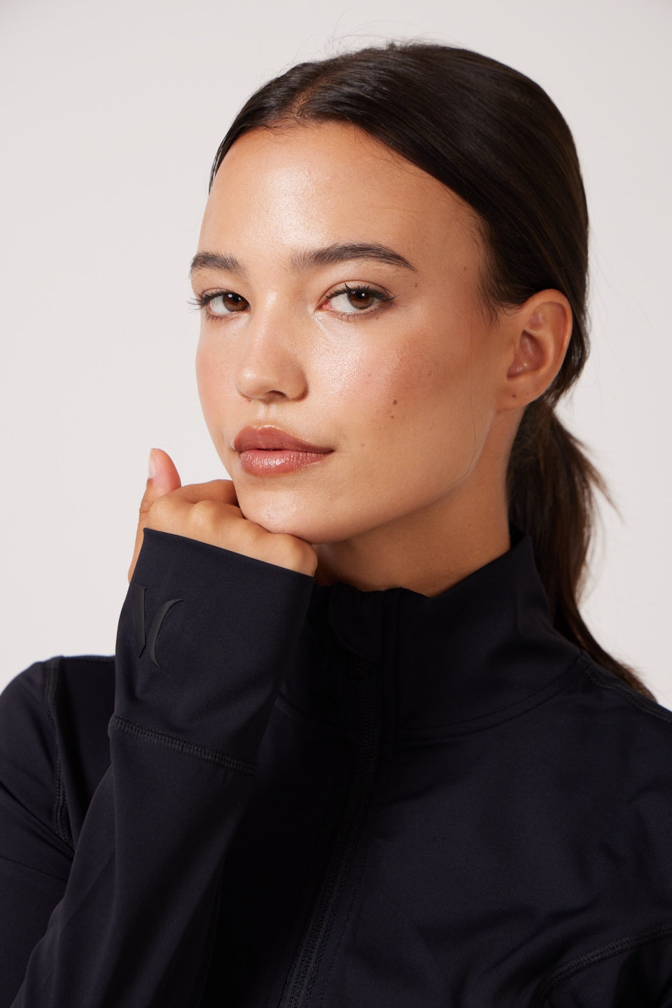 Black Lightweight performance jacket with a smooth, sculpting fit, full zip front, high collar, and stretch fabric designed for everyday movement and layering.