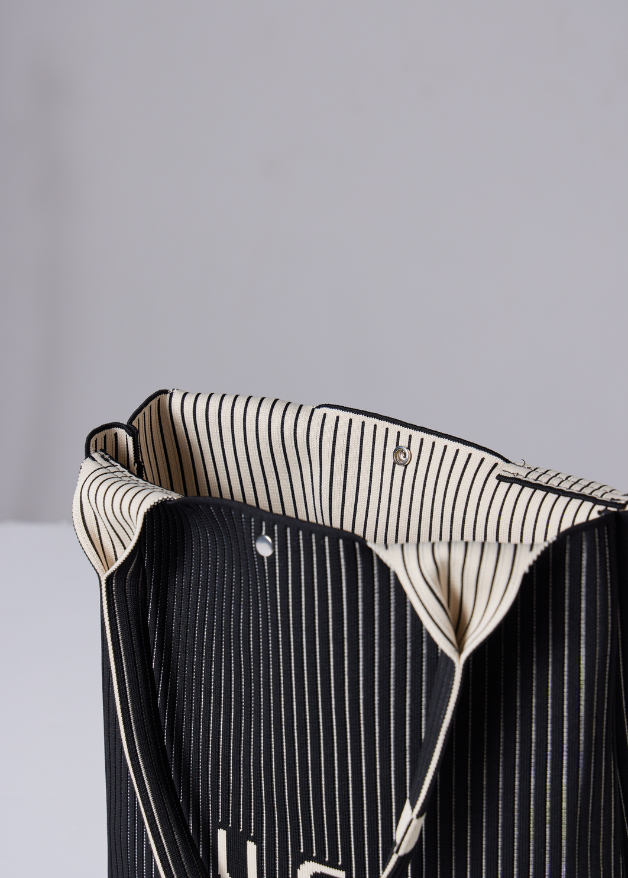 The Duck™ black woven tote bag with white pinstripes, sustainable fabric shopper with embroidered DUCK logo, reusable eco-friendly tote for everyday use