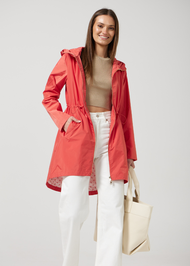 The Coral Spritz coral red hooded raincoat, modern lightweight waterproof raincoat perfect for Australia’s changing weather and rain