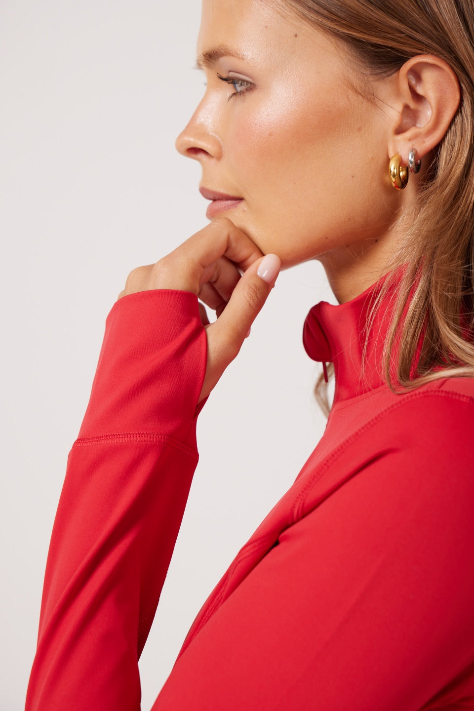 Red Lightweight performance jacket with a smooth, sculpting fit, full zip front, high collar, and stretch fabric designed for everyday movement and layering.