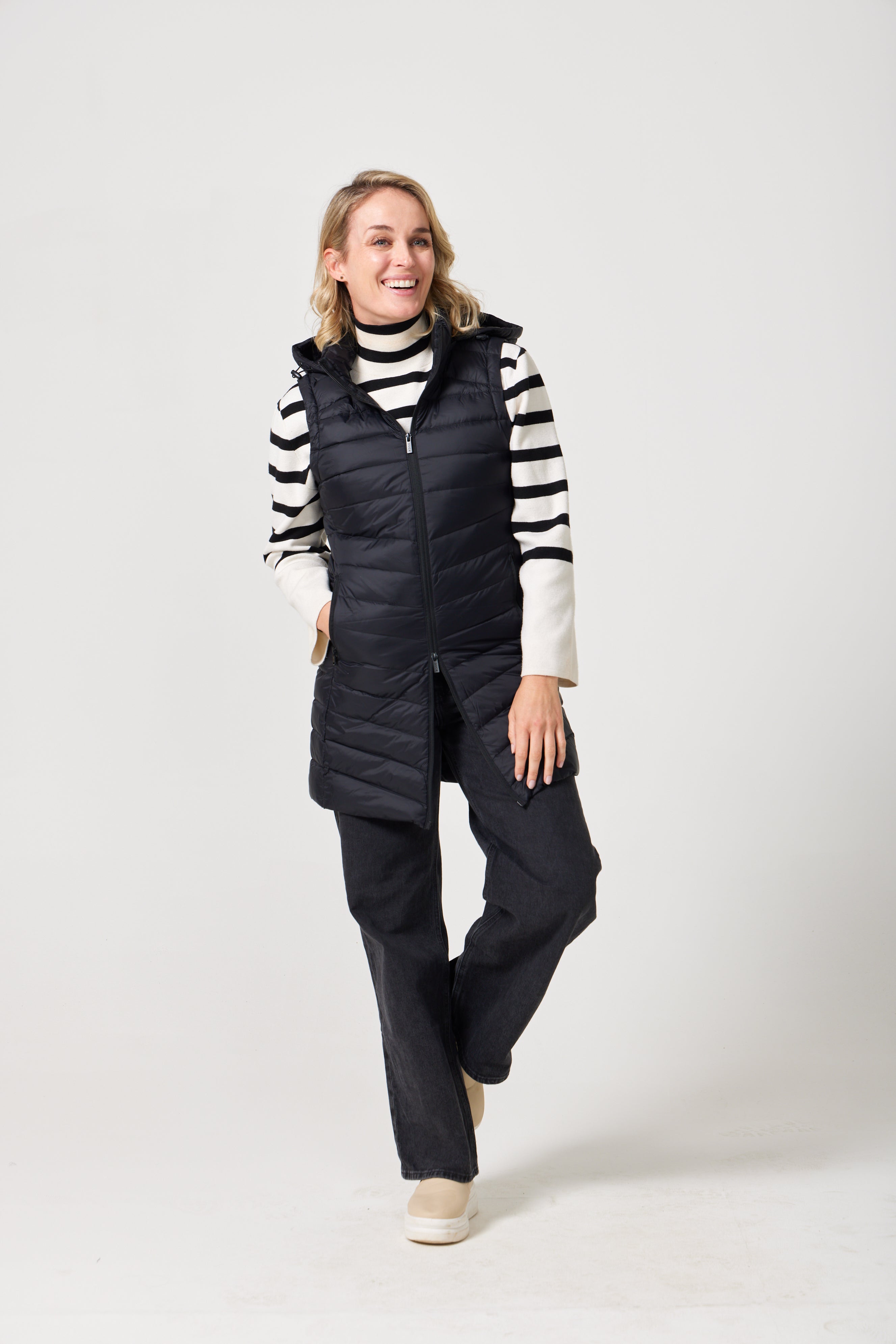 Midnight Longline Gilet™ — women’s sleeveless gilet in black, longline cut with hood, versatile layering piece for winter in Australia