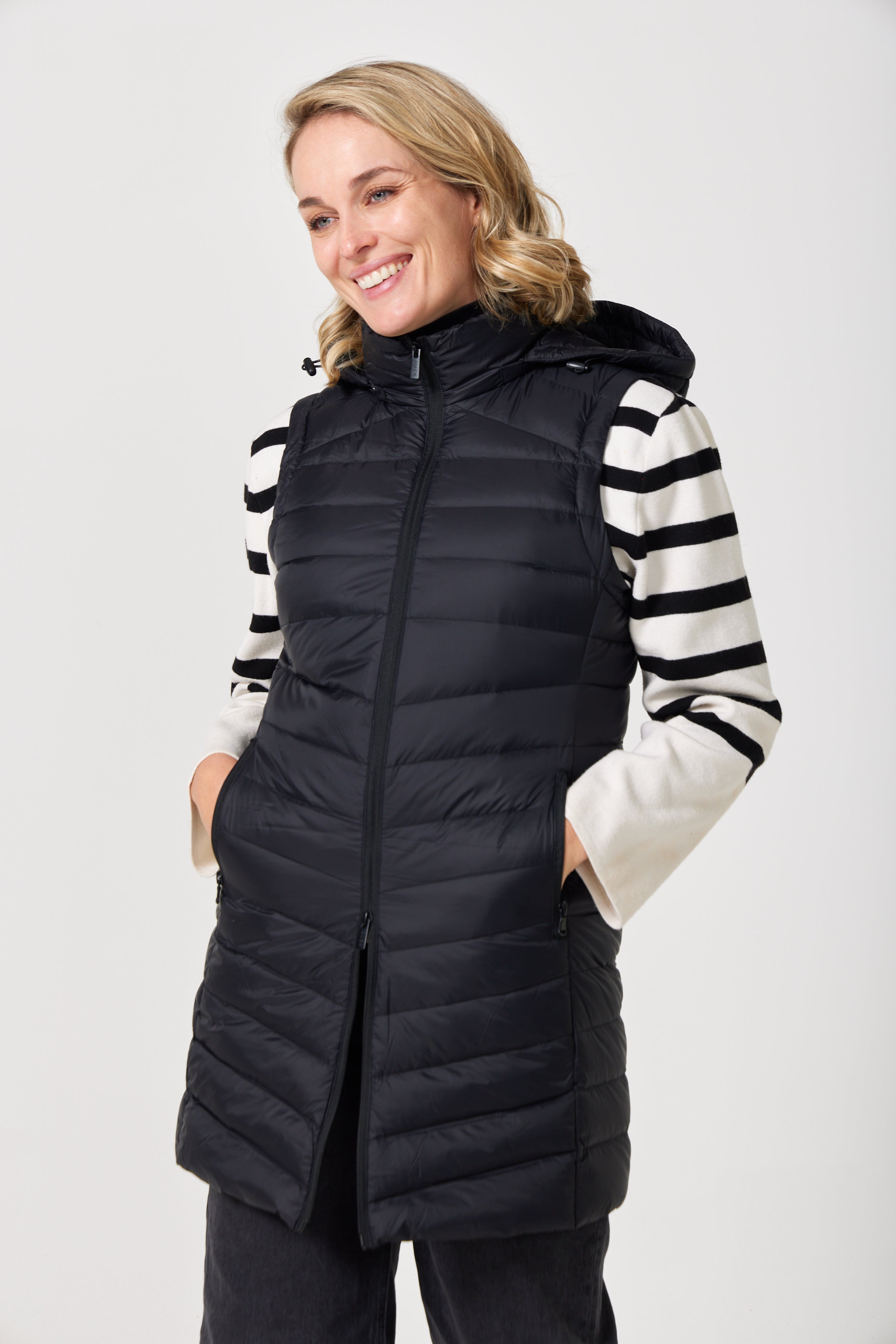 Midnight Longline Gilet™ — women’s sleeveless gilet in black, longline cut with hood, versatile layering piece for winter in Australia