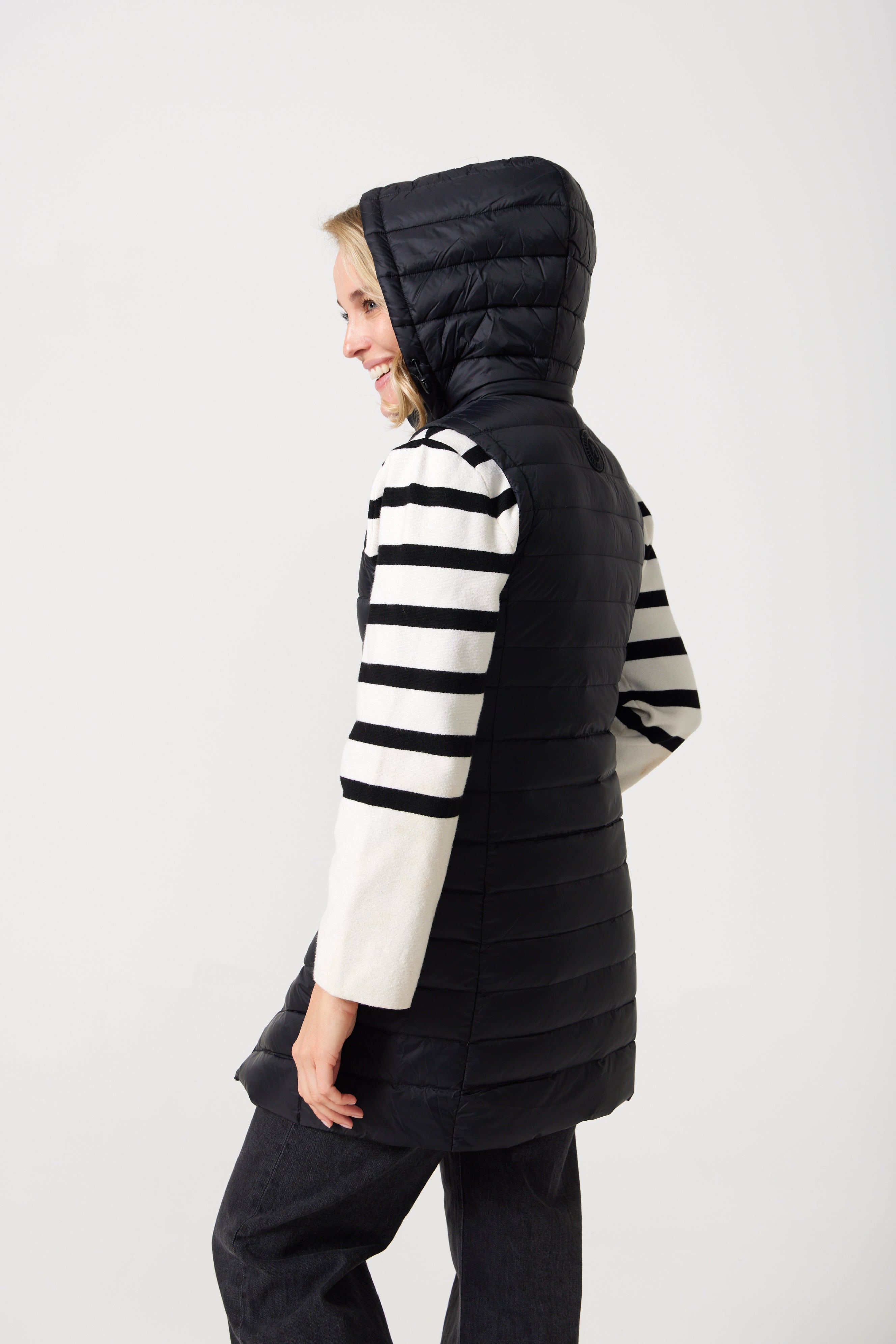 Midnight Longline Gilet™ — women’s sleeveless gilet in black, longline cut with hood, versatile layering piece for winter in Australia