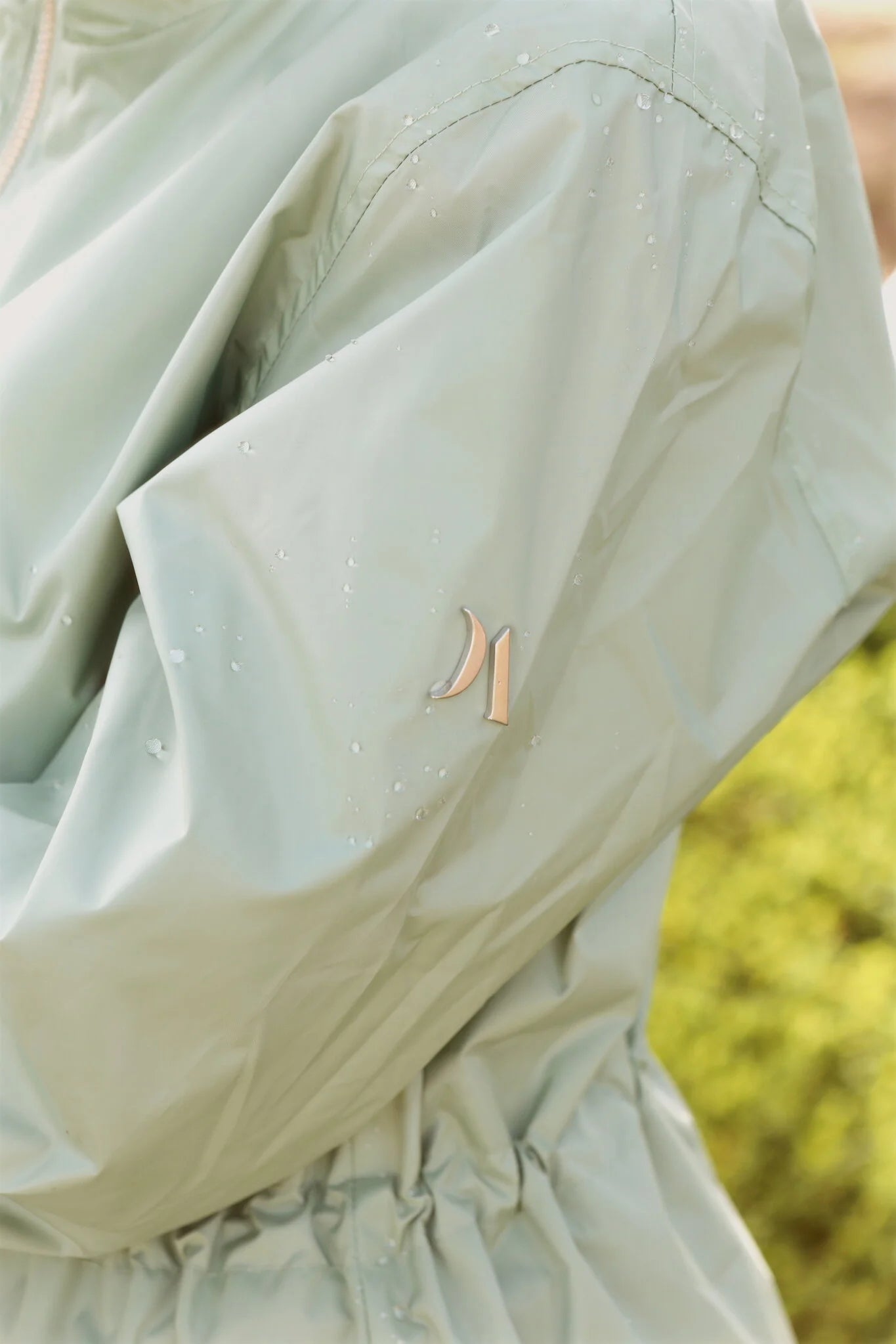 Madame Verde Vol 1 mint green hooded raincoat, lightweight waterproof jacket perfect for wet weather in Australia.