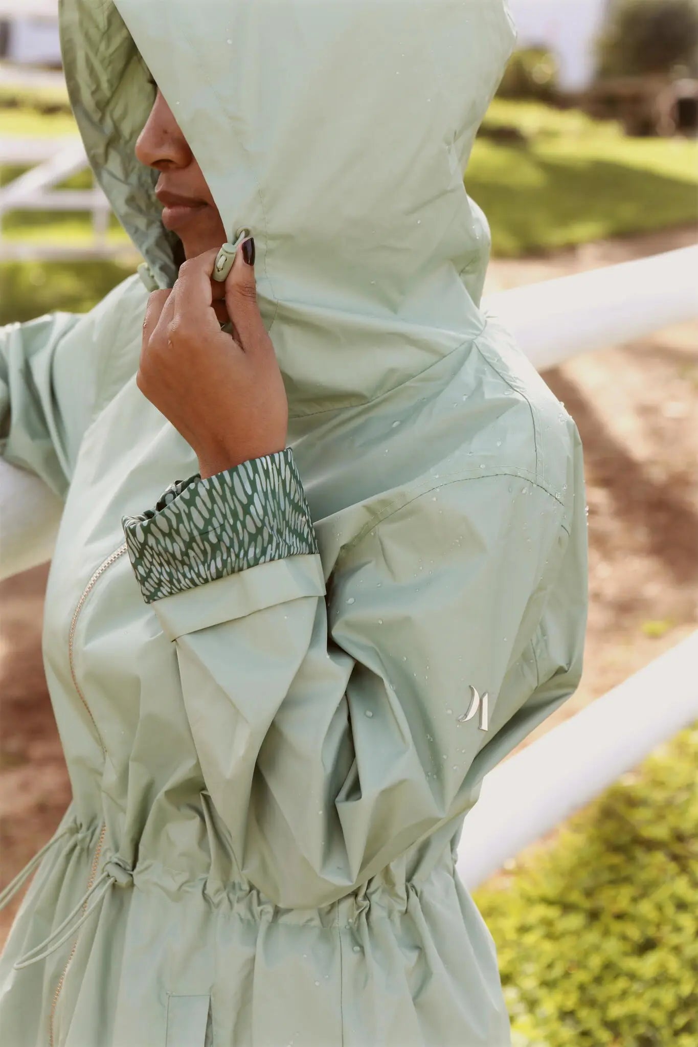 Madame Verde Vol 1 mint green hooded raincoat, lightweight waterproof jacket perfect for wet weather in Australia.