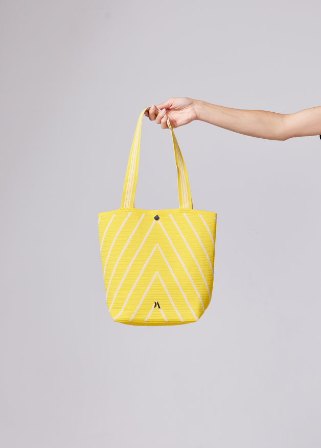 Yellow woven handbag with white diagonal stripe design, lightweight eco-friendly fabric tote bag with sturdy handles for everyday use