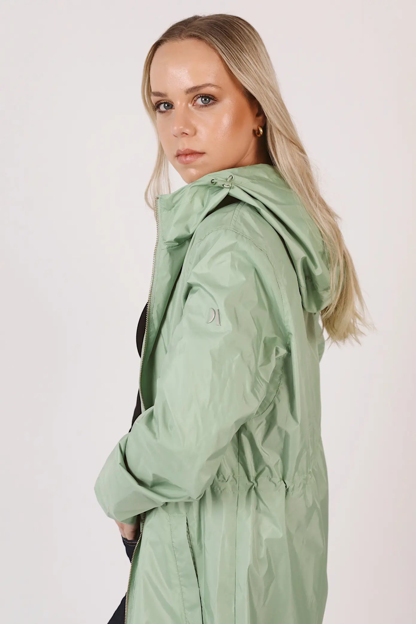 Madame Verde Vol 1 mint green hooded raincoat, lightweight waterproof jacket perfect for wet weather in Australia.