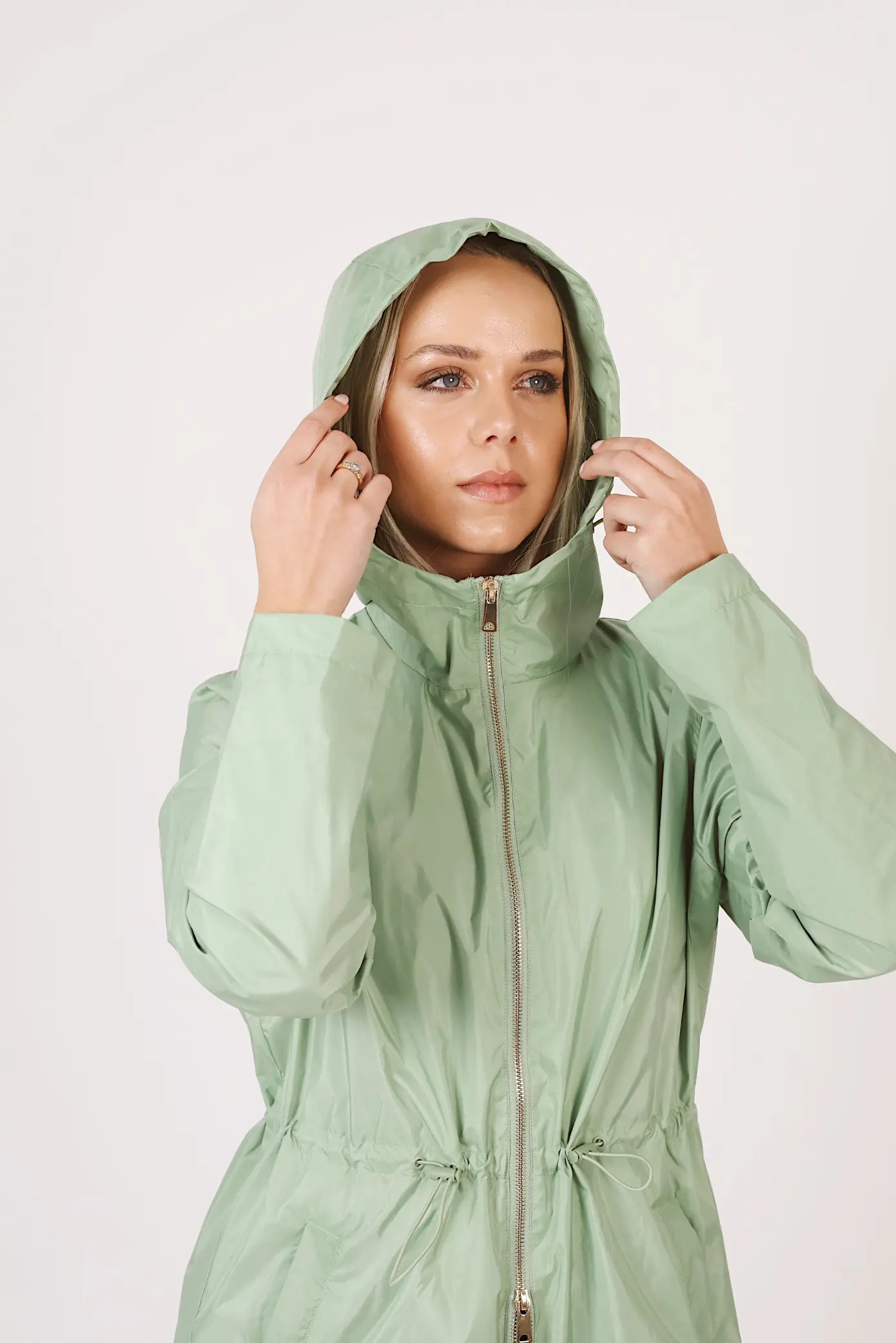 Madame Verde Vol 1 mint green hooded raincoat, lightweight waterproof jacket perfect for wet weather in Australia.