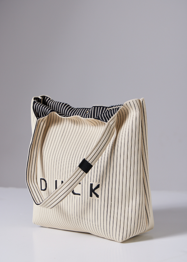 The Duck™ black woven tote bag with white pinstripes, sustainable fabric shopper with embroidered DUCK logo, reusable eco-friendly tote for everyday use