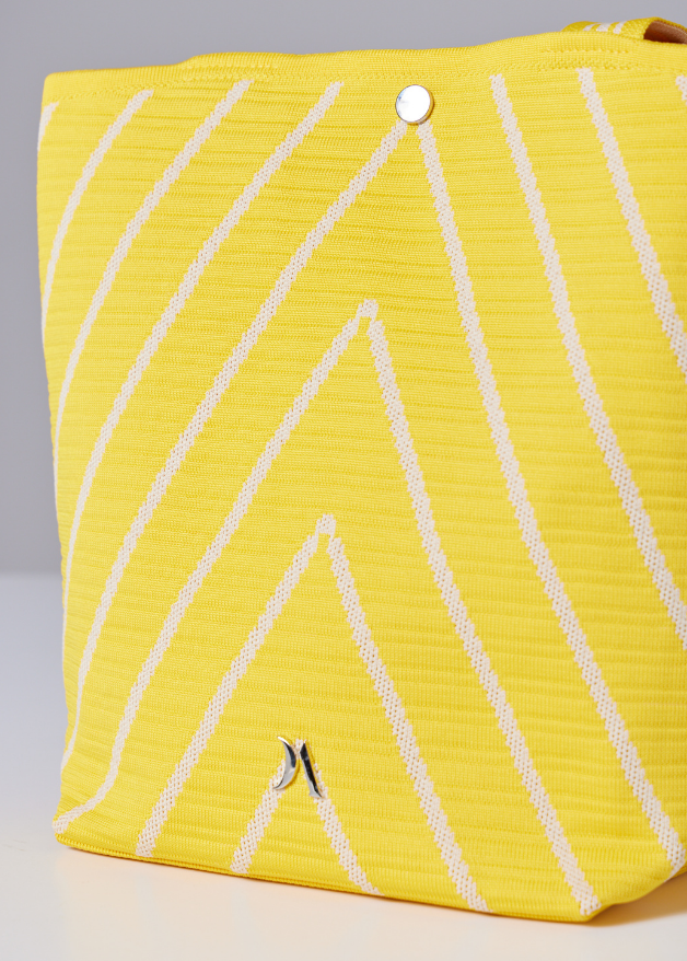 Yellow woven handbag with white diagonal stripe design, lightweight eco-friendly fabric tote bag with sturdy handles for everyday use