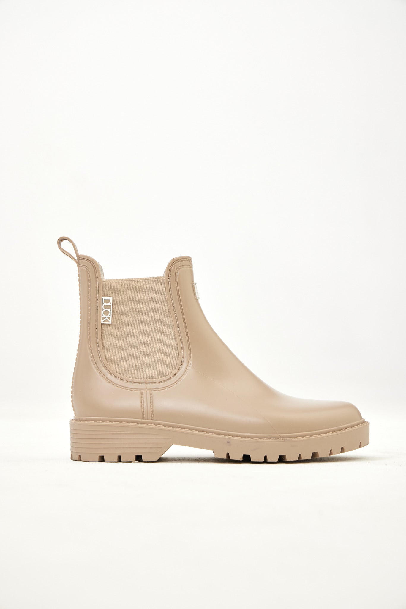 Beige Ankle-length gumboots with elastic side panels and durable sole, designed for everyday outdoor and wet-weather use