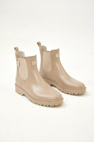 Beige Ankle-length gumboots with elastic side panels and durable sole, designed for everyday outdoor and wet-weather use