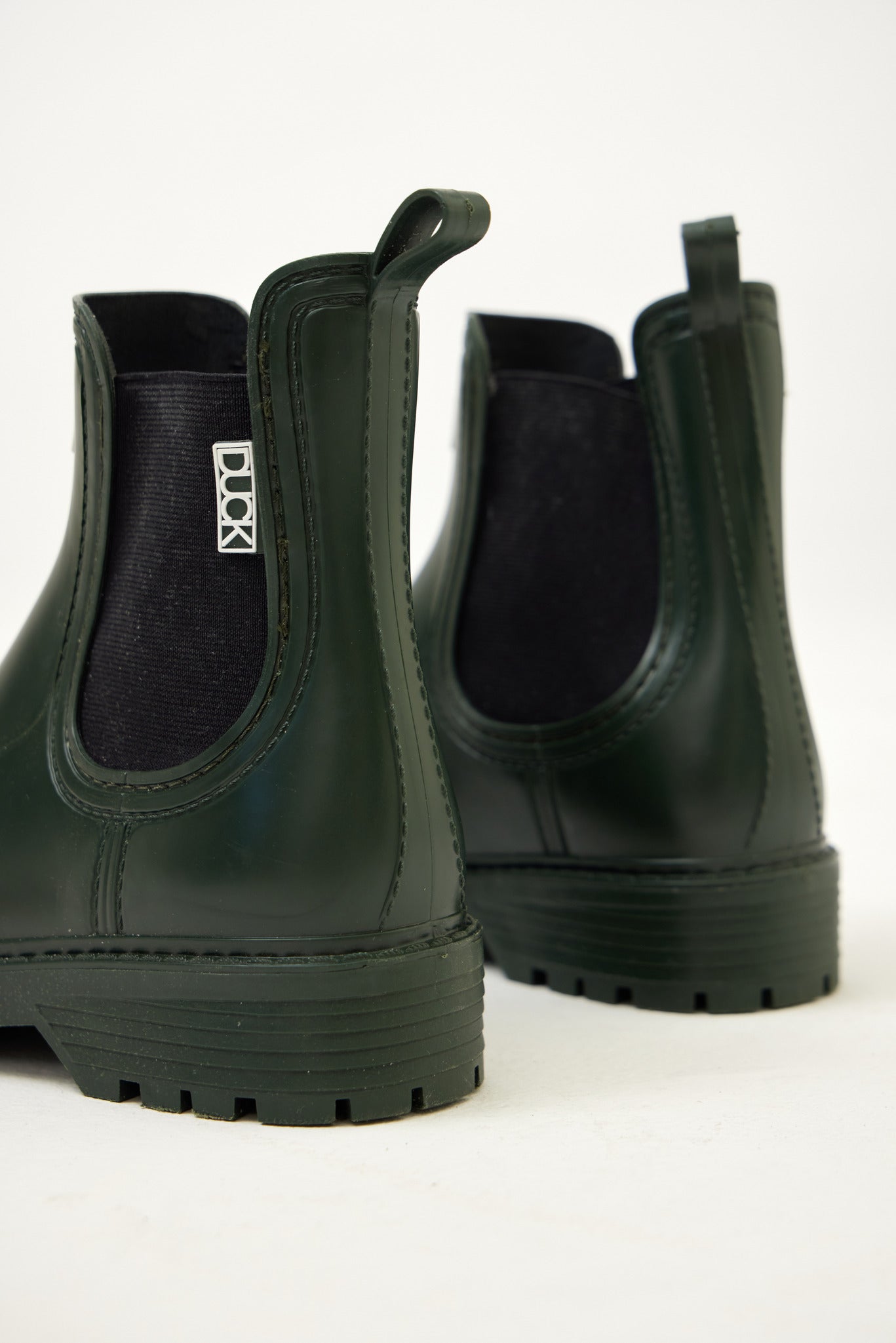 Green Ankle-length gumboots with elastic side panels and durable sole, designed for everyday outdoor and wet-weather use
