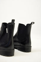 Black Ankle-length gumboots with elastic side panels and durable sole, designed for everyday outdoor and wet-weather use