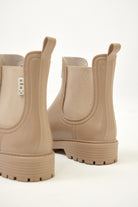 Beige Ankle-length gumboots with elastic side panels and durable sole, designed for everyday outdoor and wet-weather use