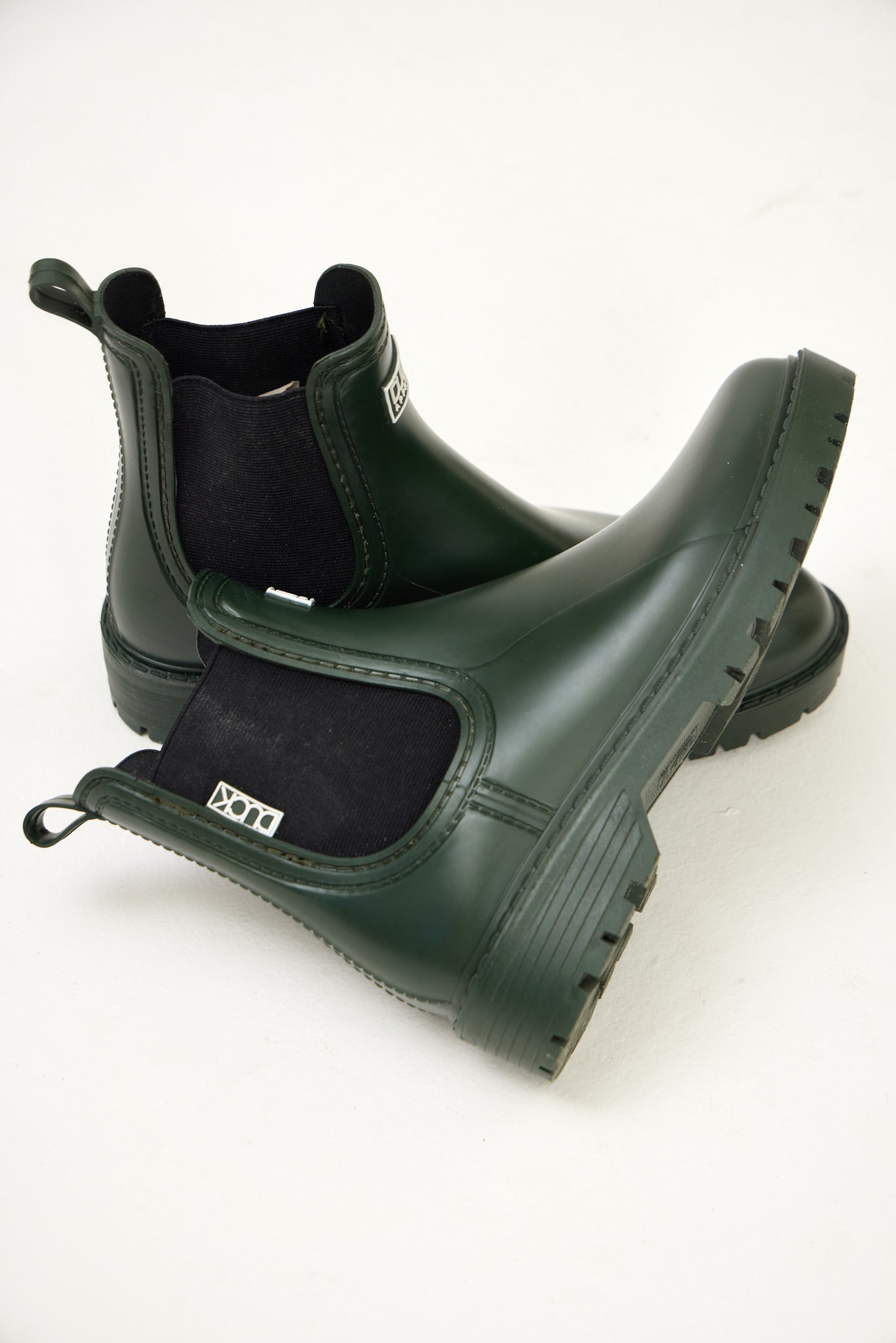 Green Ankle-length gumboots with elastic side panels and durable sole, designed for everyday outdoor and wet-weather use