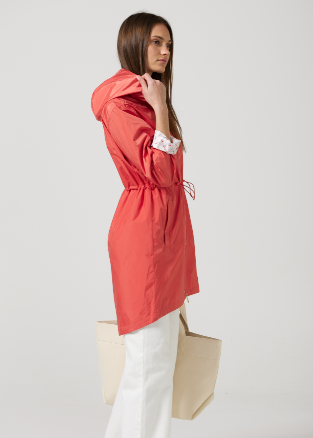 The Coral Spritz coral red hooded raincoat, modern lightweight waterproof raincoat perfect for Australia’s changing weather and rain