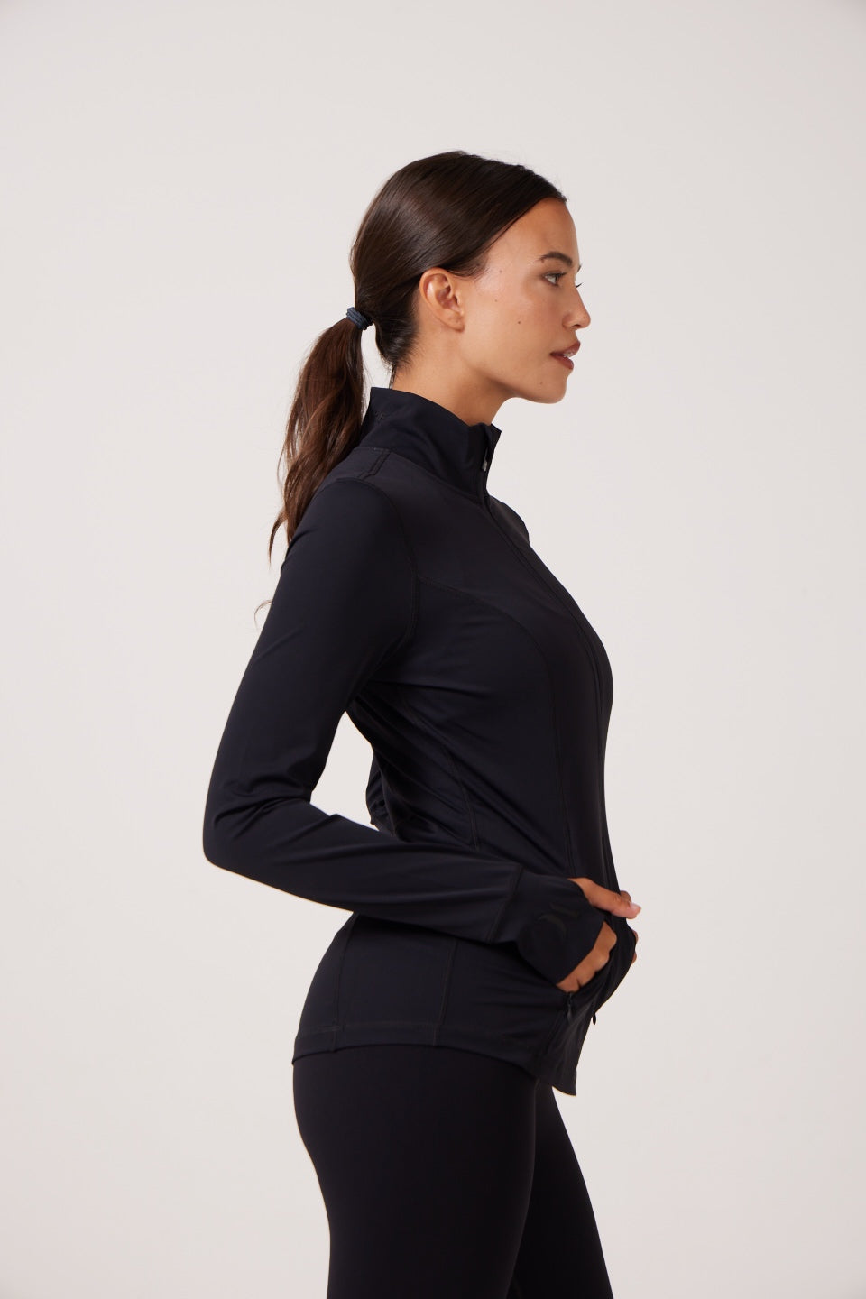 Black Lightweight performance jacket with a smooth, sculpting fit, full zip front, high collar, and stretch fabric designed for everyday movement and layering.