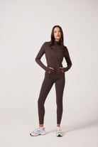 Brown Lightweight performance jacket with a smooth, sculpting fit, full zip front, high collar, and stretch fabric designed for everyday movement and layering.