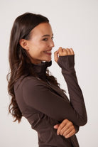 Brown Lightweight performance jacket with a smooth, sculpting fit, full zip front, high collar, and stretch fabric designed for everyday movement and layering.