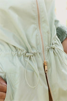 Madame Verde Vol 1 mint green hooded raincoat, lightweight waterproof jacket perfect for wet weather in Australia.