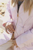 Rosewater Mist pastel pink hooded raincoat, modern lightweight waterproof raincoat perfect for wet weather in Australia.