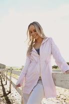 Rosewater Mist pastel pink hooded raincoat, modern lightweight waterproof raincoat perfect for wet weather in Australia.