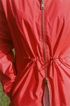 Lipstick Crush No 5 bright red hooded raincoat, modern lightweight waterproof raincoat perfect for wet weather in Australia