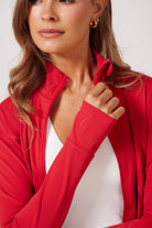 Red Lightweight performance jacket with a smooth, sculpting fit, full zip front, high collar, and stretch fabric designed for everyday movement and layering.