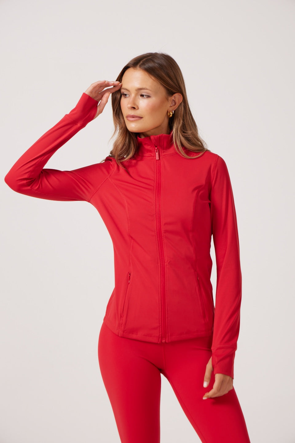Red Lightweight performance jacket with a smooth, sculpting fit, full zip front, high collar, and stretch fabric designed for everyday movement and layering.